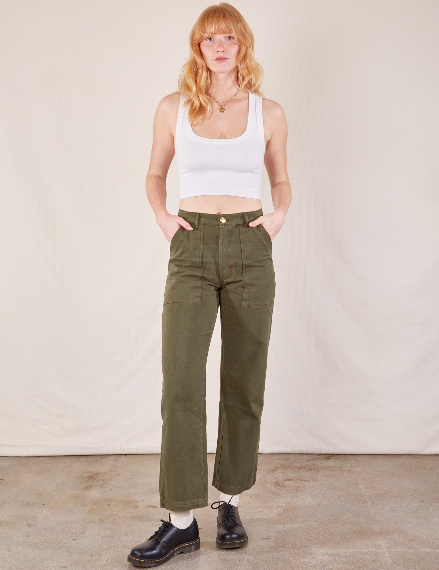 Margaret is 5&#39;11” and wearing XS Work Pants in Surplus Green paired with a Cropped Tank in vintage tee off-white