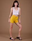 Angled front view of Classic Work Shorts in Sunshine Yellow and vintage tee white Cropped Tank on Alex