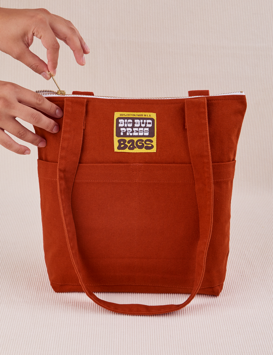 Over-Shoulder Zip Mini Tote in Paprika with model holding zipper