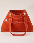 Overall Handbag in Paprika with one strap laying down the front