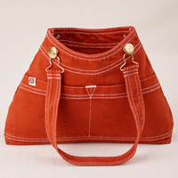 Overall Handbag in Paprika with one strap laying down the front