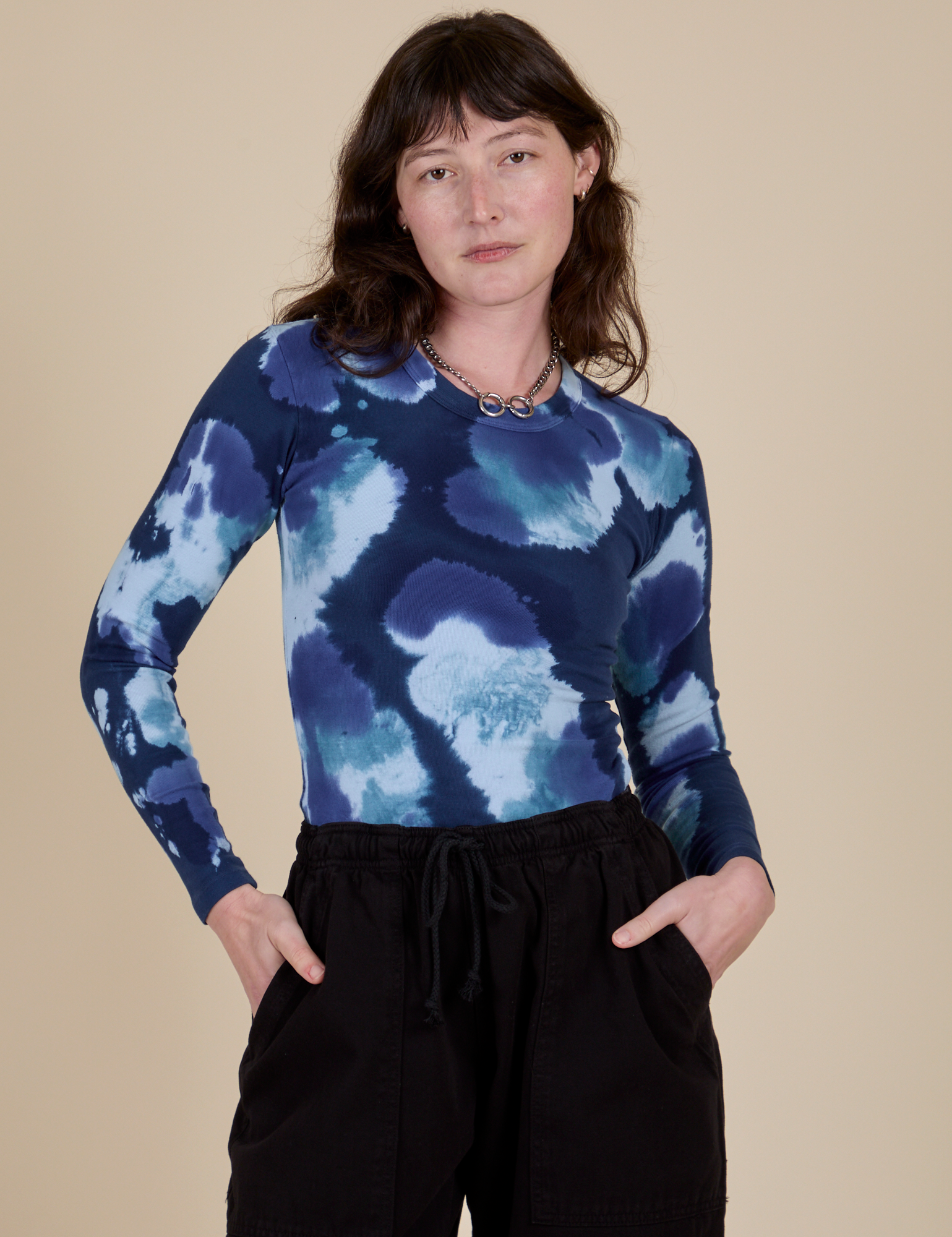 Alex is 5’8” and wearing P Long Sleeve Baby Tee in Blue Magic Waters