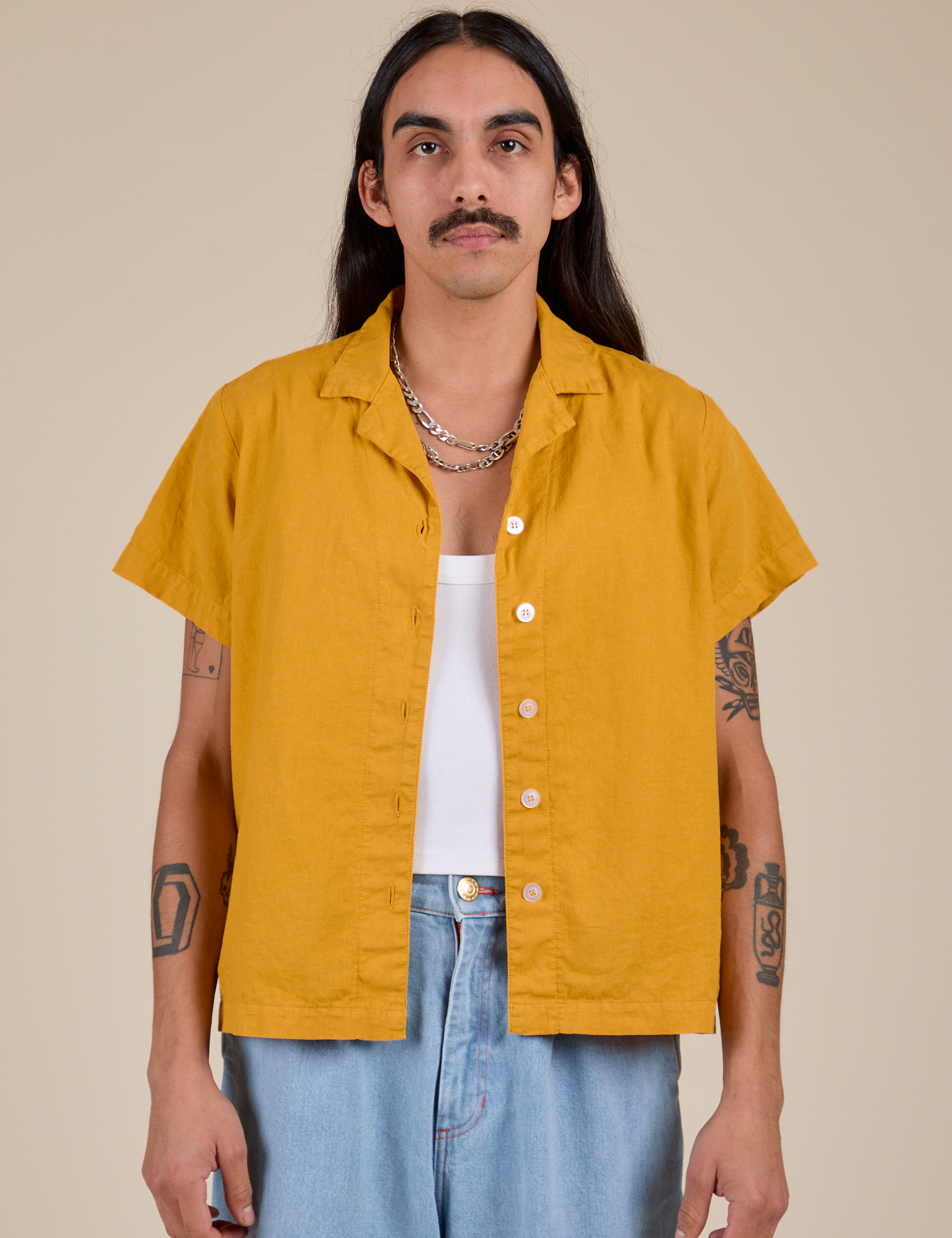 Anthony is 5’6” and wearing S Pantry Button-Up in Mustard Yellow