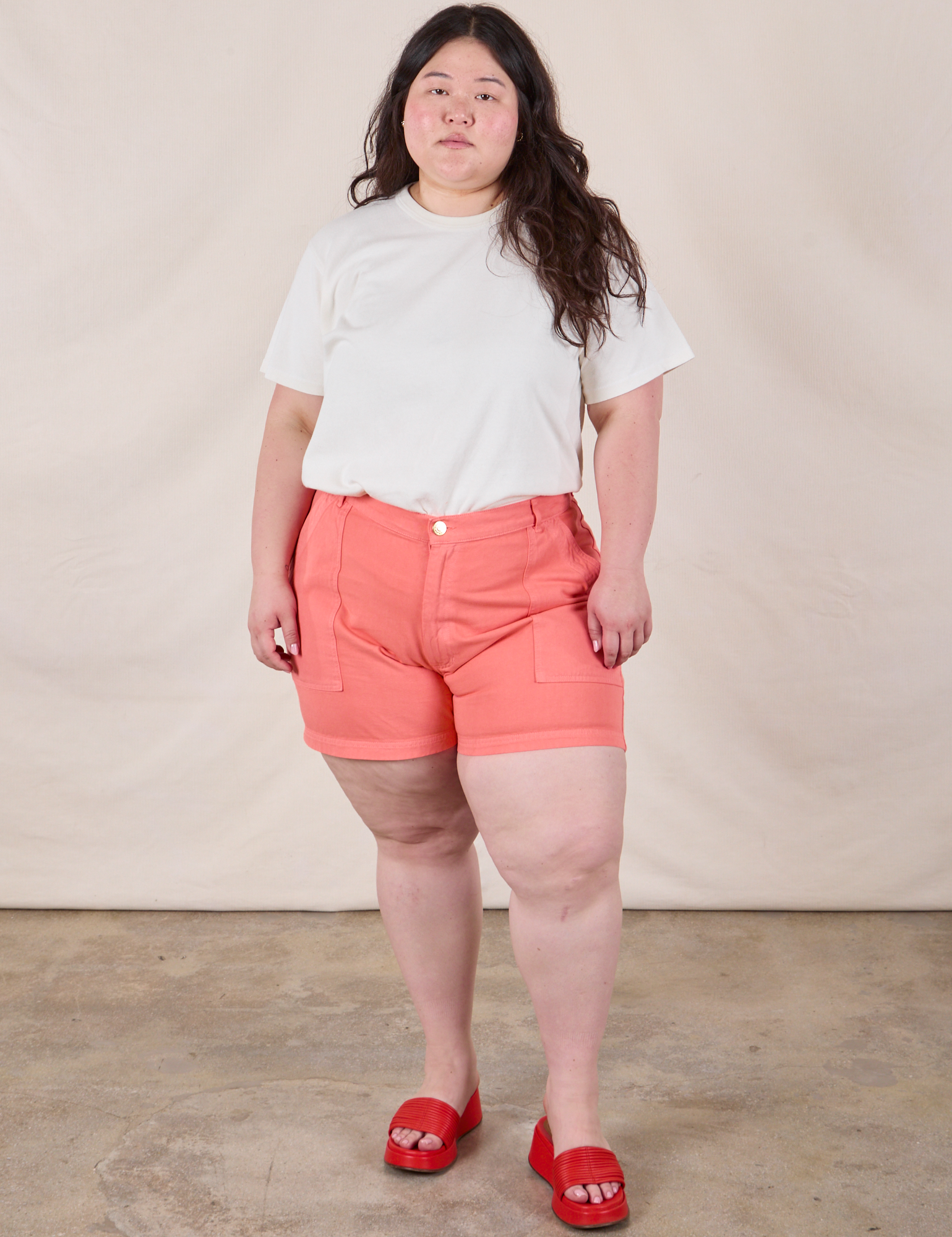 Ashley is 5’7” and wearing 1XL Classic Work Shorts in Flamingo Pink paired with an Organic Vintage Tee in Vintage Tee Off-White