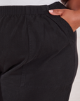 Action Pants in Basic Black front pocket close up. Morgan has her hand in the pocket.