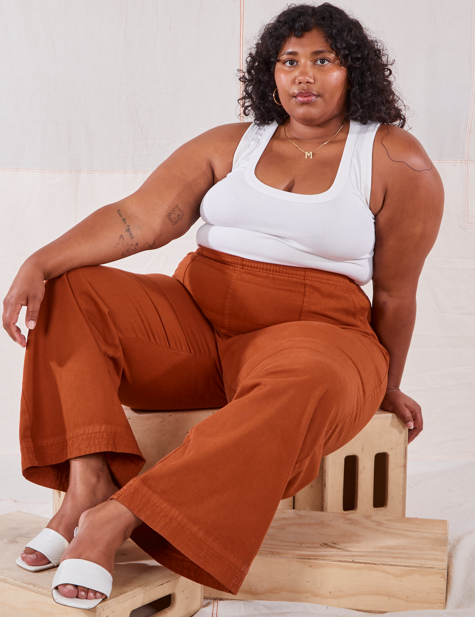 Morgan is wearing Action Pants in Burnt Terracotta and Cropped Tank in vintage tee off-white