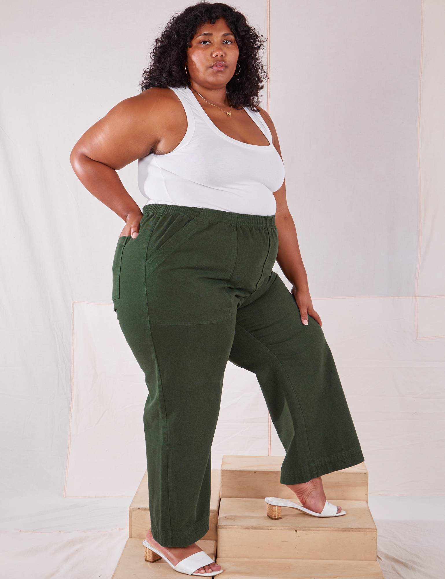 Side view of Action Pants in Swamp Green and Cropped Tank in vintage tee off-white on Morgan