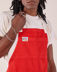 Full Denim Apron in Mustang Red close up on Jerrod