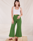 Alex is 5'8" and wearing XXS Bell Bottoms in Lawn Green paired with vintage off-white Cropped Tank Top