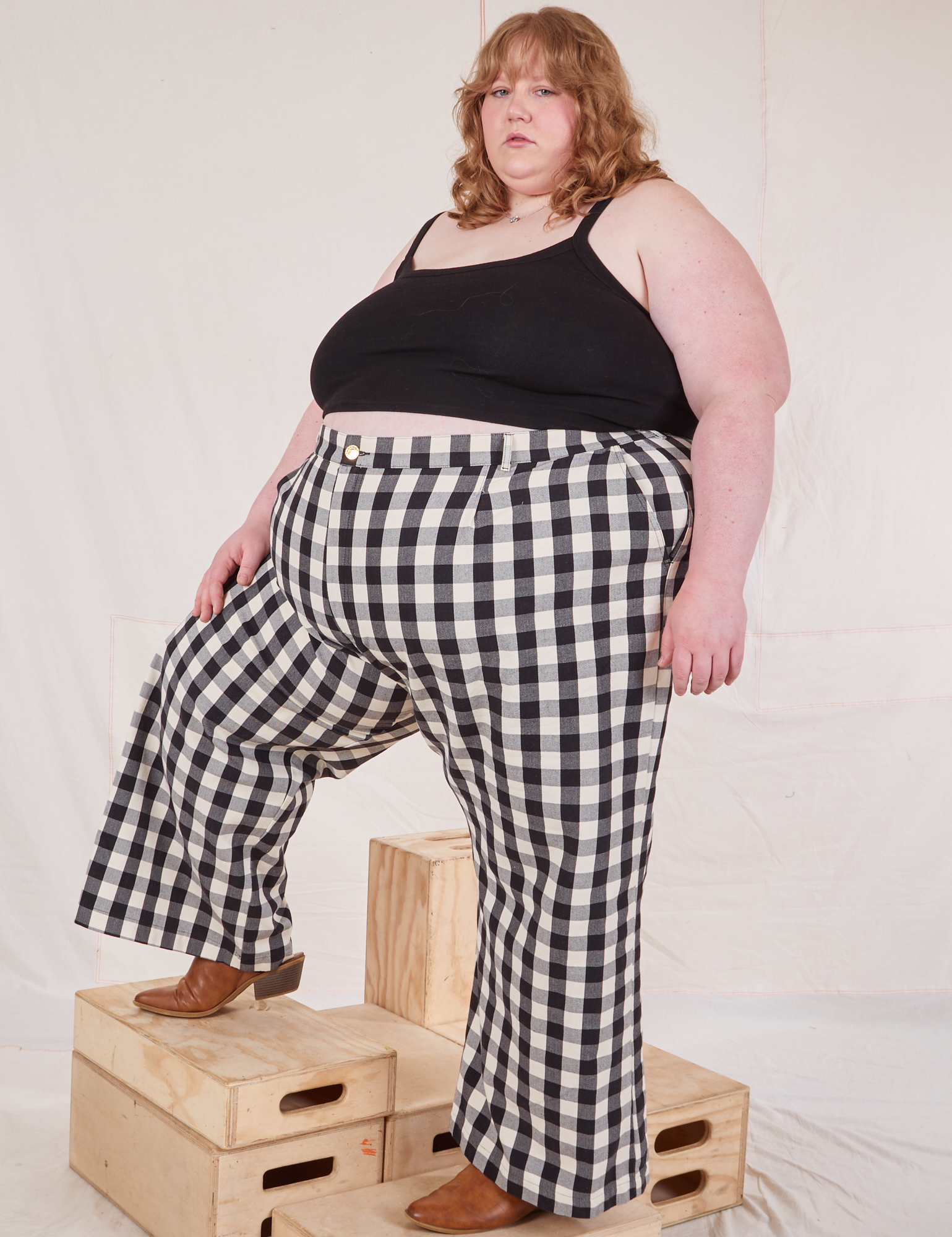 Angled front view of Wide Leg Trousers in Big Gingham and black Cropped Cami on Catie