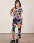 Hana is 5'3" and wearing XXS Petite Petite Short Sleeve Jumpsuit in Rainbow Magic Waters