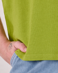 Burly Tee in Gross Green bottom hem close up on Quinn