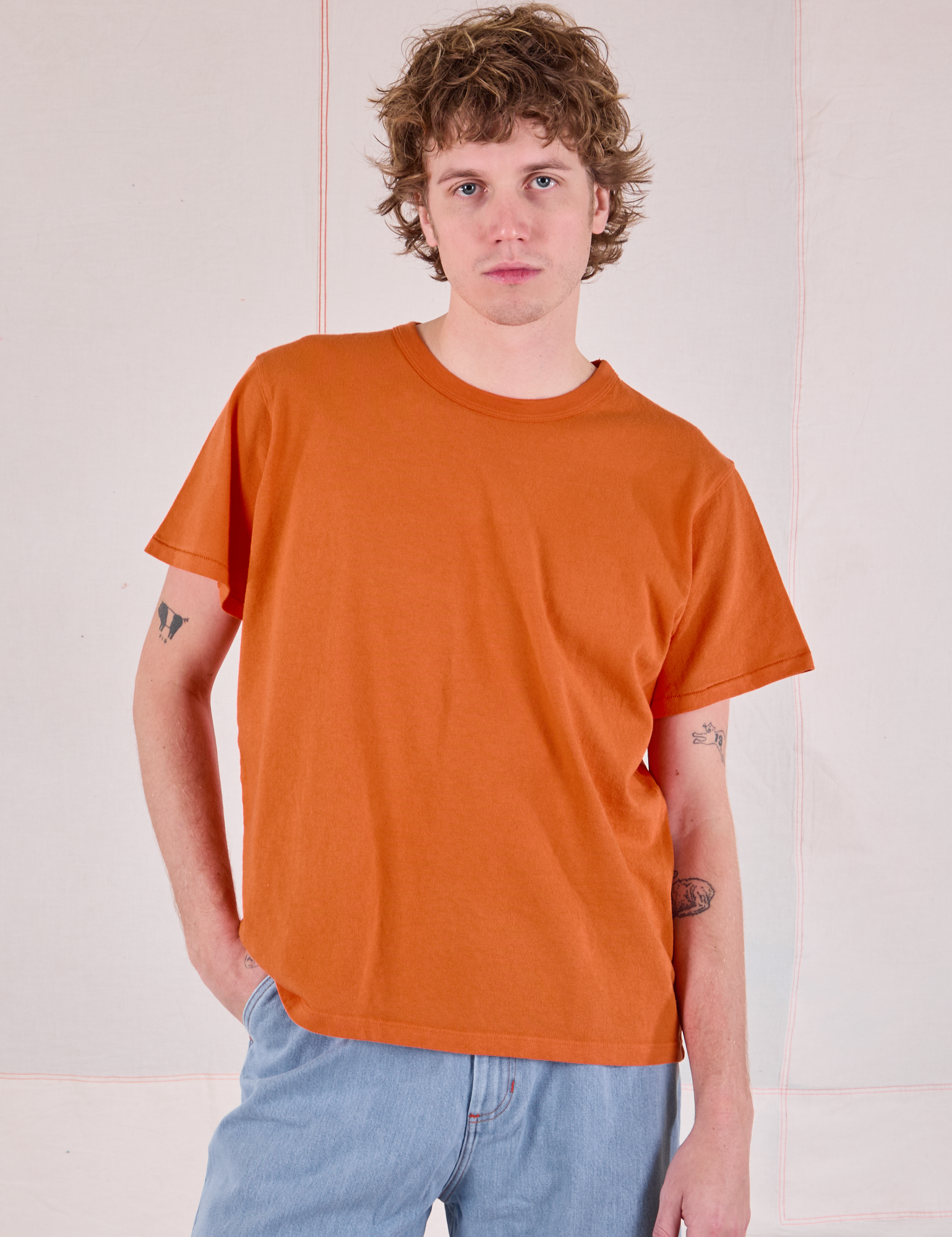 Quinn is 6&#39;3&quot; and wearing S Burly Tee in Construction Orange