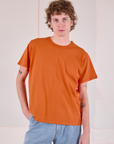 Quinn is 6'3" and wearing S Burly Tee in Construction Orange