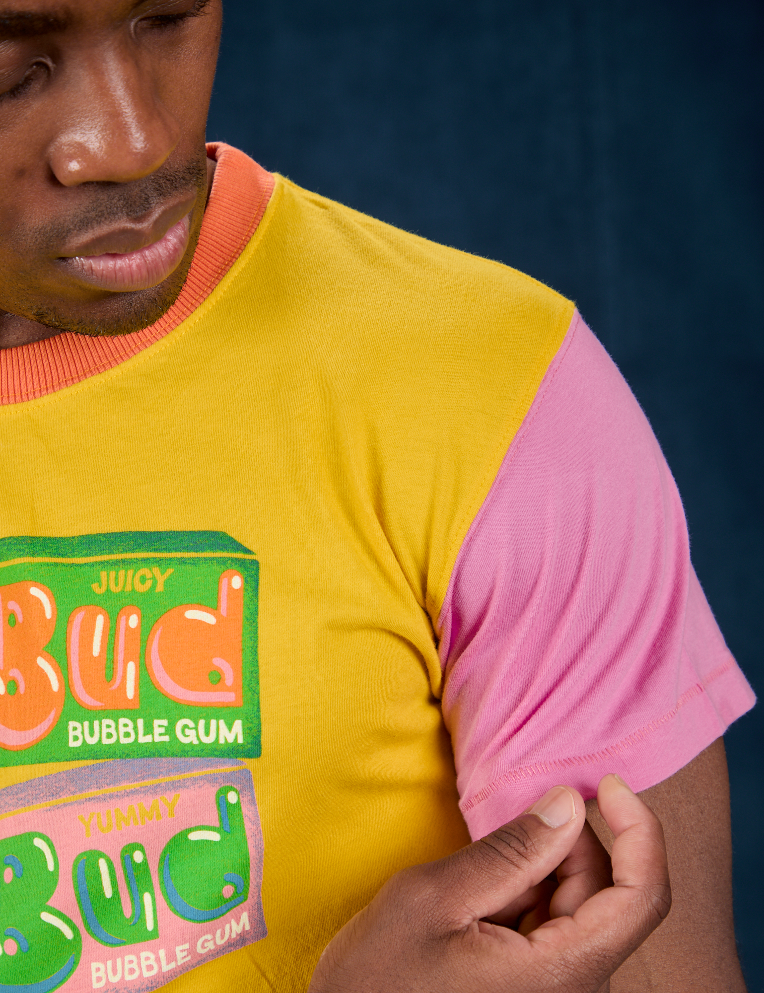 Vintage Tee in Bubblegum front shoulder close up with Isaac touching pink sleeve