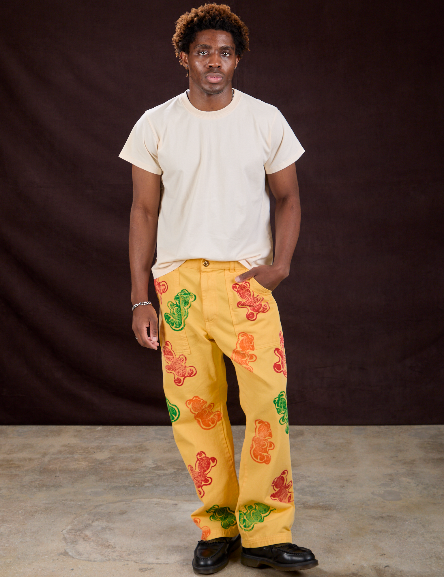 Isaac is 5&#39;10&quot; and wearing M Gummy Bear Paintstamped Work Pants in Butter Yellow paired with an Organic Vintage Tee in Vintage Off-White