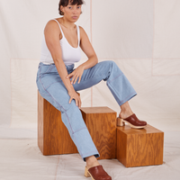 Tiara is wearing Carpenter Jeans in Light Wash and vintage off-white Cami