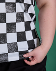 Checker Organic Tee in Black bottom close up with Ashley holding the hem