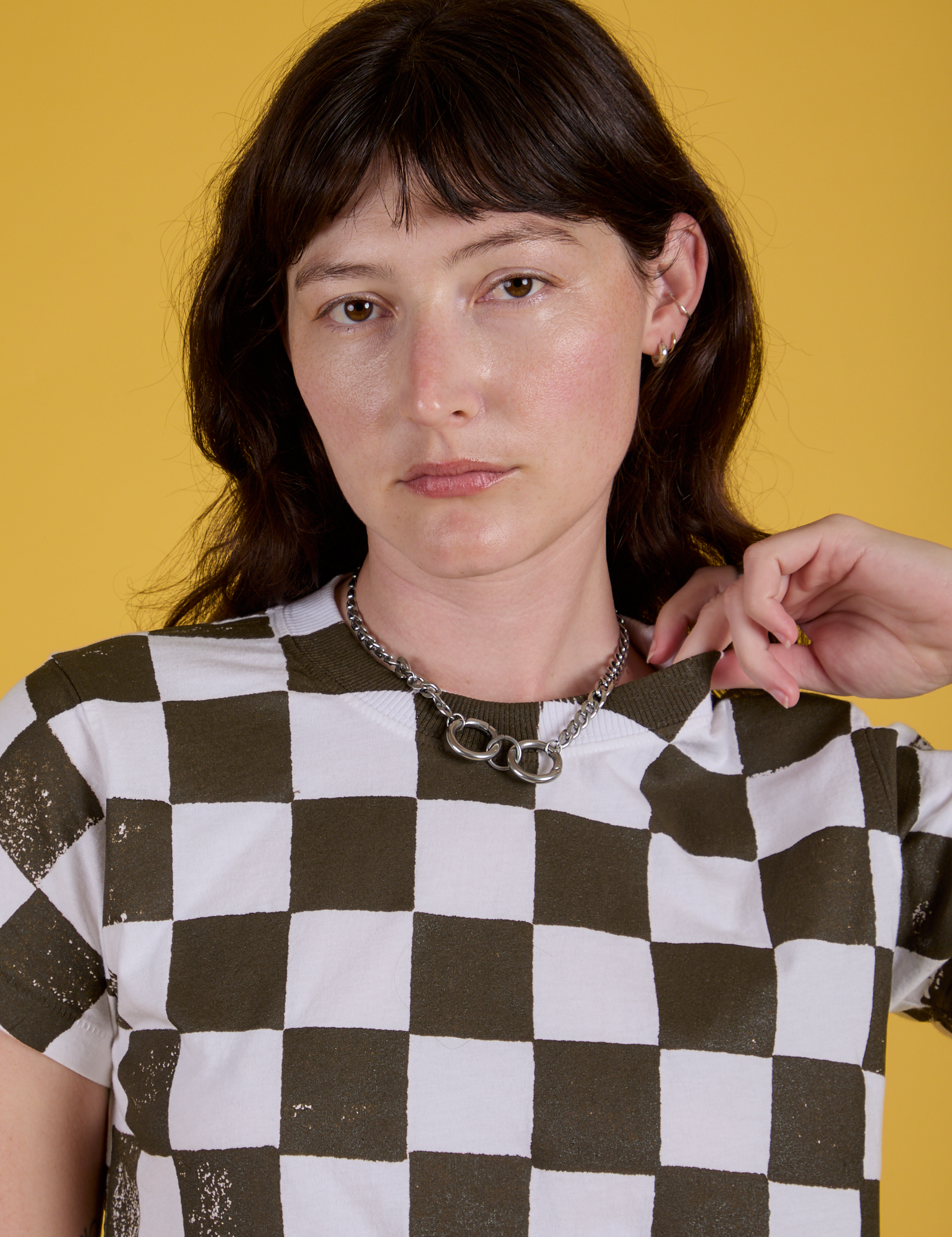 Checker Organic Tee in Espresso Brown front close up on Alex