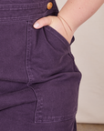 Front pocket close up of Original Overalls in Mono Nebula Purple. Ashley has her hand in the pocket.