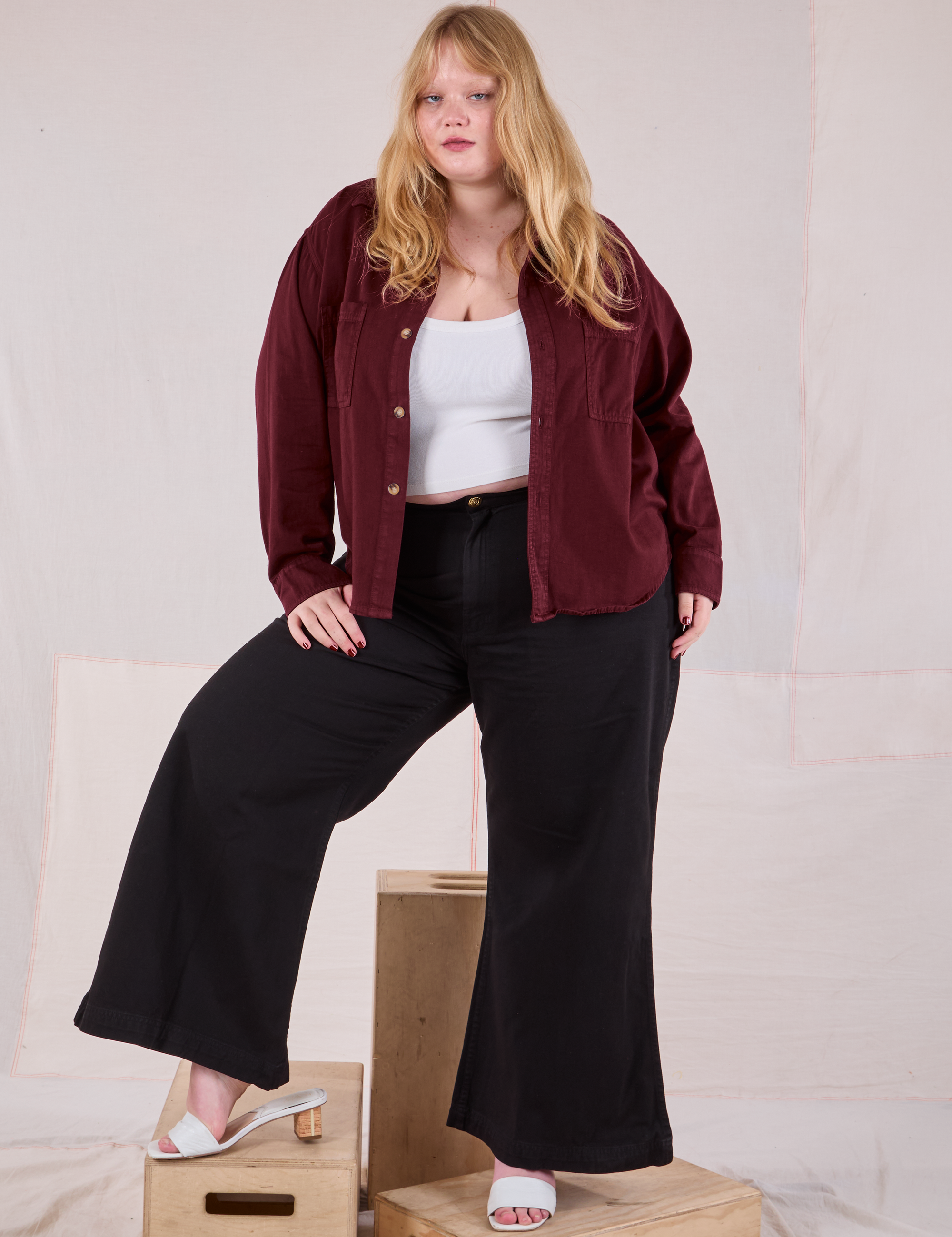 Juliet is wearing Cropped Overshirt in Red Wine and basic black Bell Bottoms