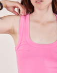 Cropped Tank Top in Bubblegum Pink front close up. Hana is touching the top of the strap.