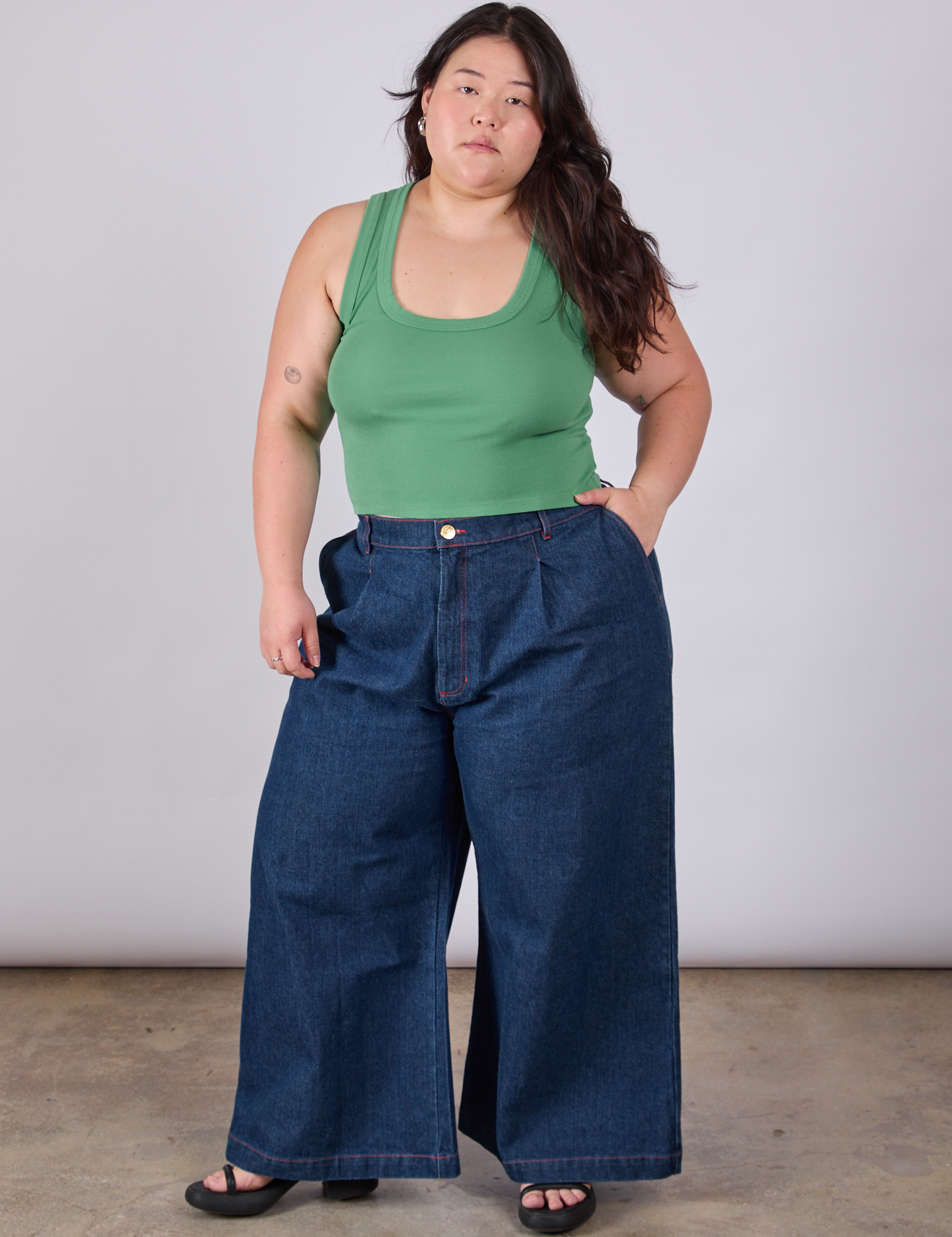 Ashley is wearing Cropped Tank Top in Seafoam Green paired with dark wash Indigo Wide Leg Trousers
