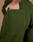 Close up of Alex's hand in the back pocket of Drop Pocket Cargo Pants in Evergreen