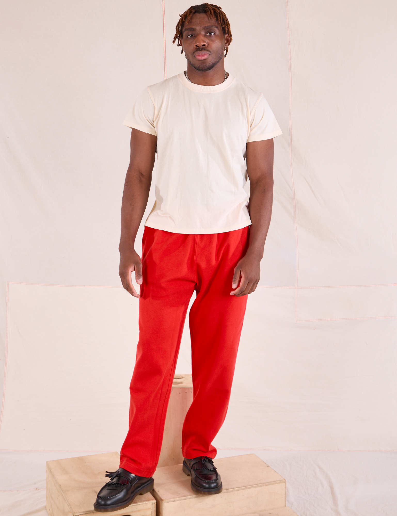 Issac is 5&#39;10&quot; and wearing M Easy Pants in Mustang Red paired with an Organic Vintage Tee in Vintage Tee Off-White