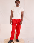 Issac is 5'10" and wearing M Easy Pants in Mustang Red paired with an Organic Vintage Tee in Vintage Tee Off-White