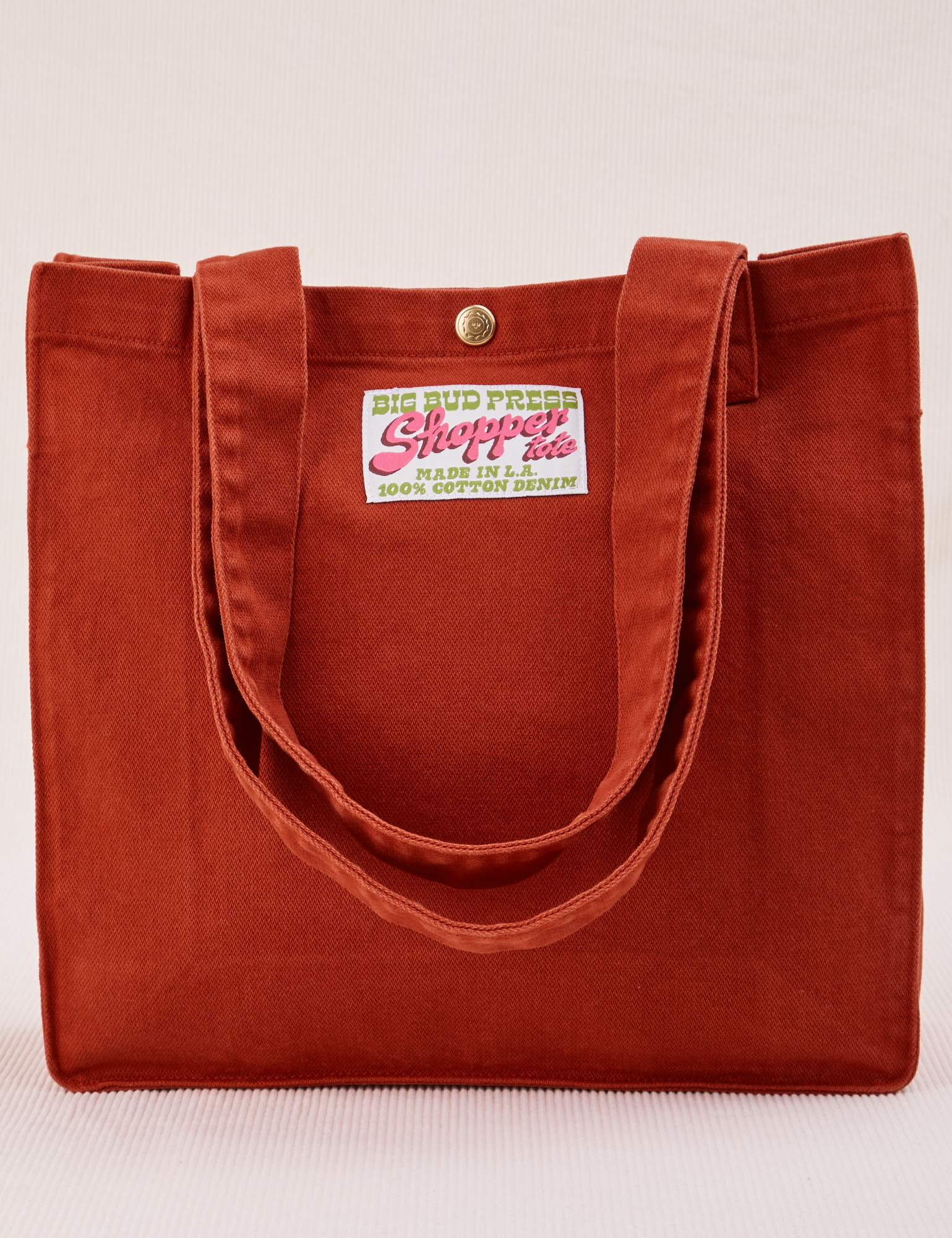 Shopper Tote Bag in Paprika with straps laying down front of bag