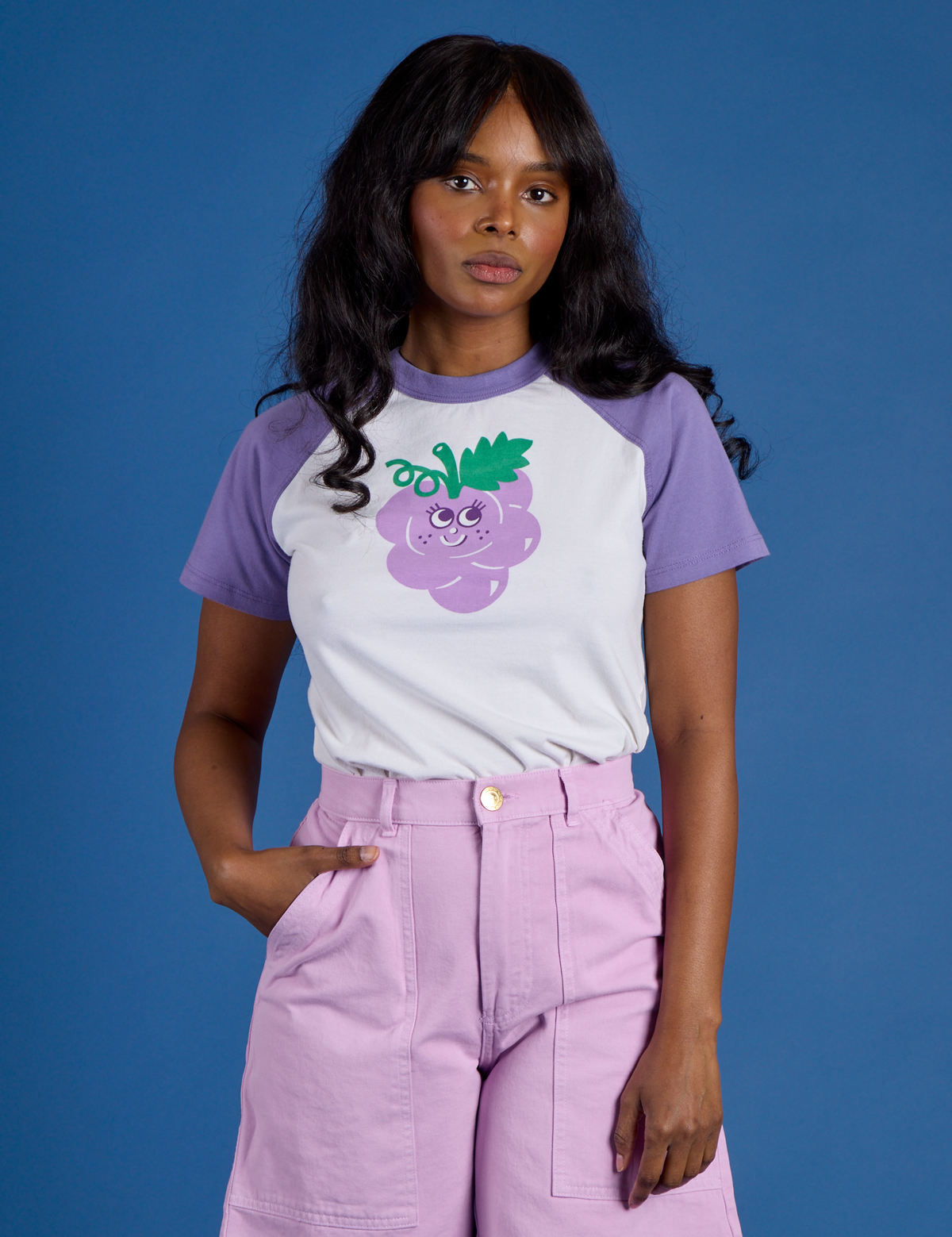 Kandia is 5’3” and wearing P Produce Raglan Tee in Grape