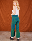 Angled back view of Gingham Western Pants in Green and Cropped Tank in vintage tee off-white on Margaret