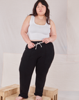 Ashley is 5'7" and wearing L Rolled Cuff Sweat Pants in Basic Black paired with vintage off-white Cropped Tank