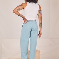 Back view of Heavyweight Trousers in Baby Blue and vintage off-white Sleeveless Turtleneck worn by Jesse
