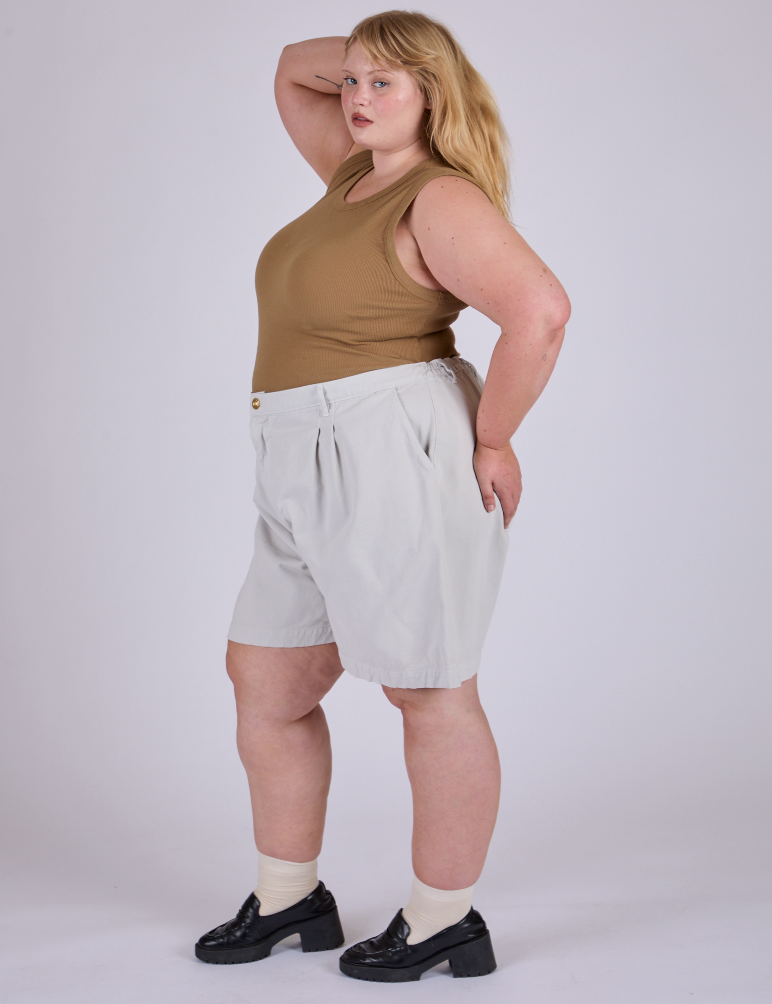 Side view of Pleated Trouser Shorts in Dishwater White and desert brown Muscle Tee on Juliet