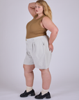 Side view of Pleated Trouser Shorts in Dishwater White and desert brown Muscle Tee on Juliet