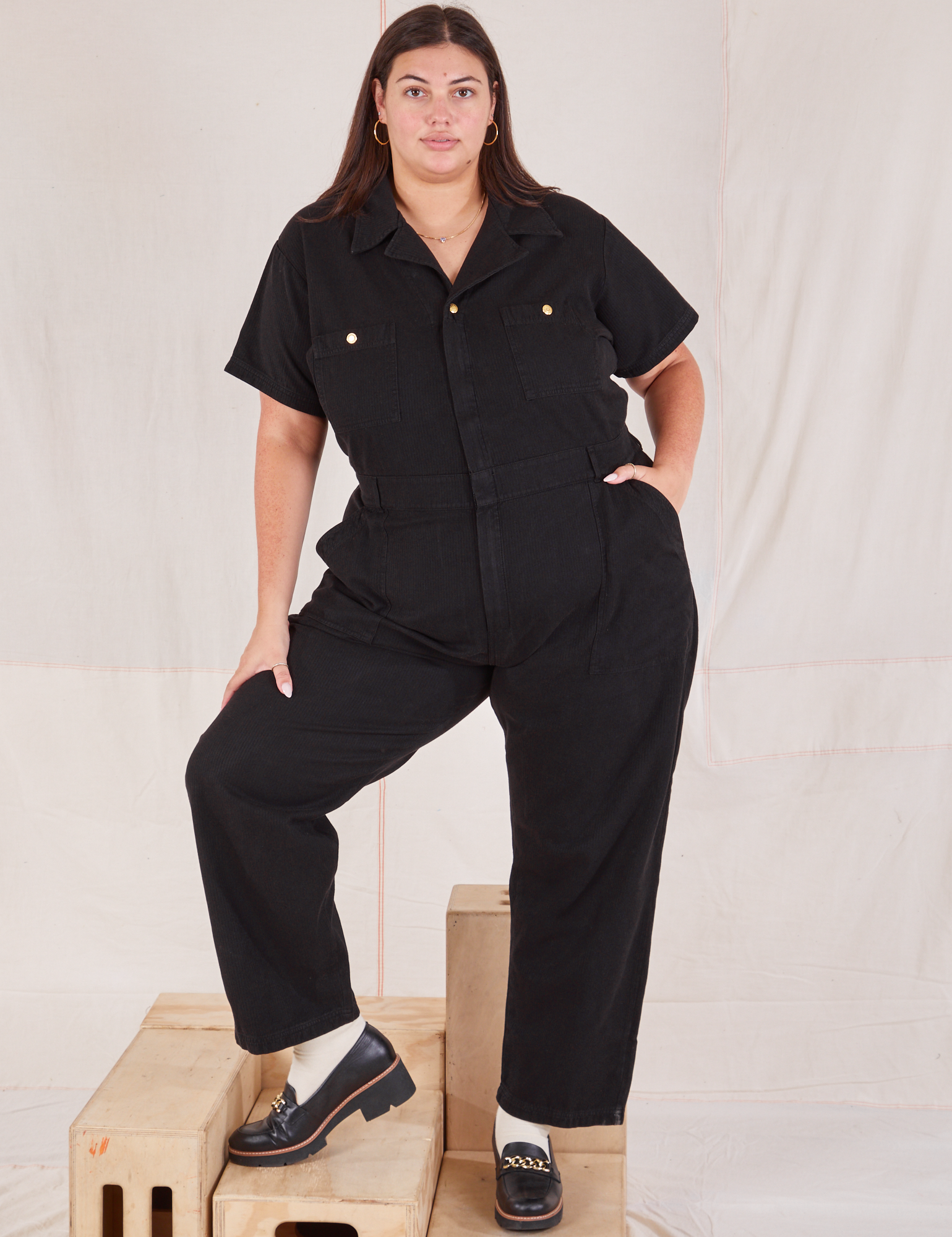 Katie is 6’2” and wearing 2XL Heritage Short Sleeve Jumpsuit in Basic Black