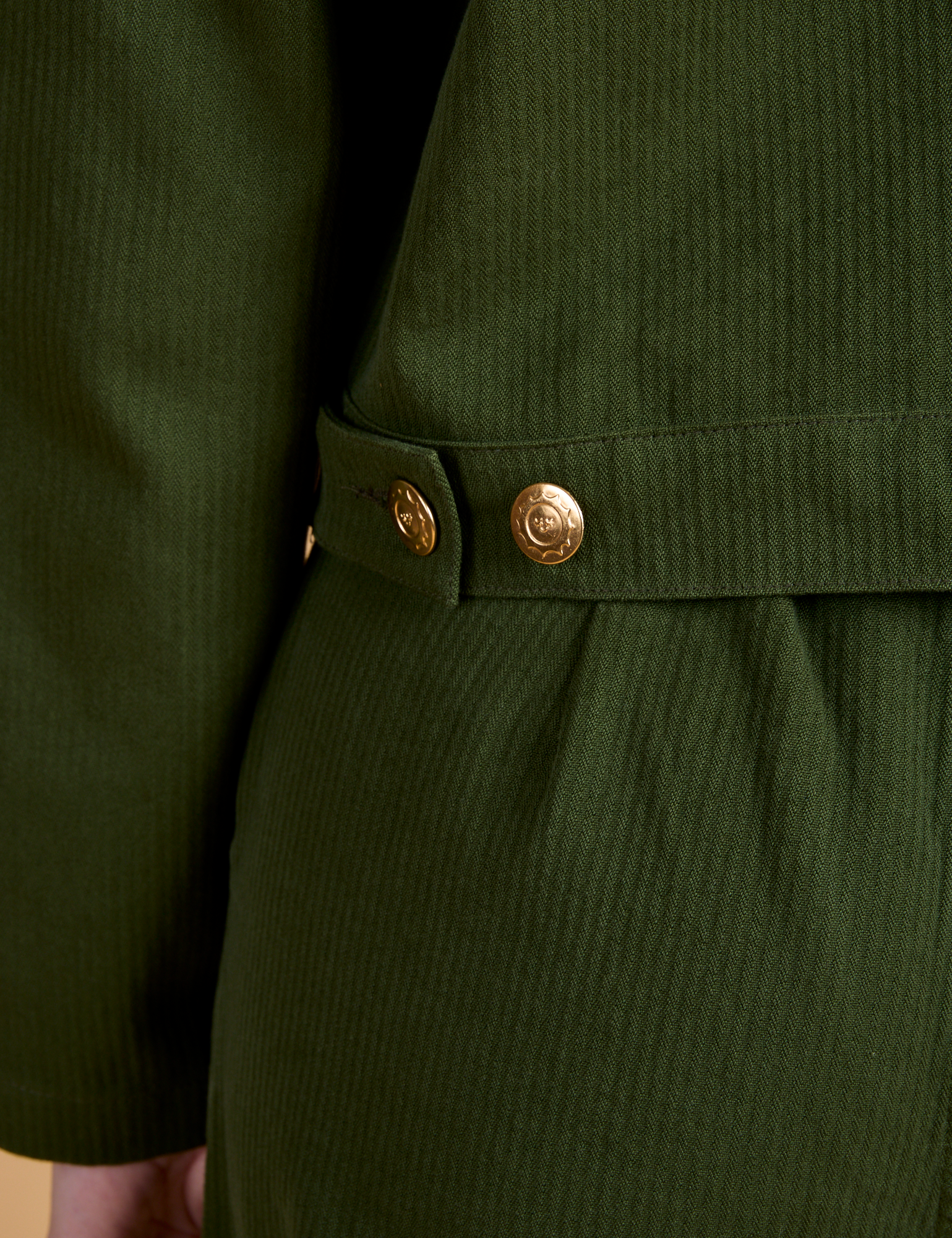 Close up of brass side snaps on Heritage Mechanic Jacket in Evergreen