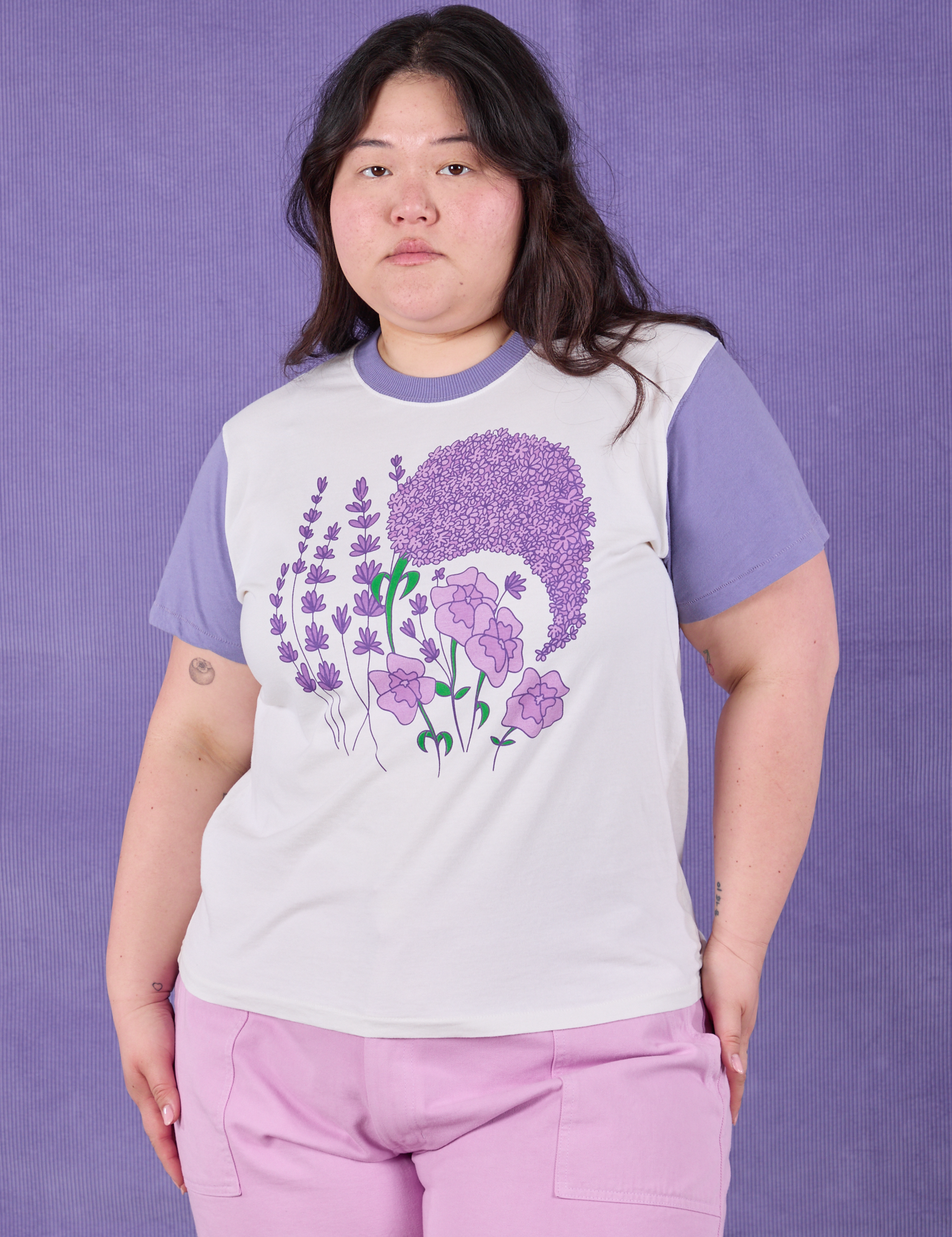 Ashley is 5’7” and wearing L Anniversary Tee in Lush Lilac