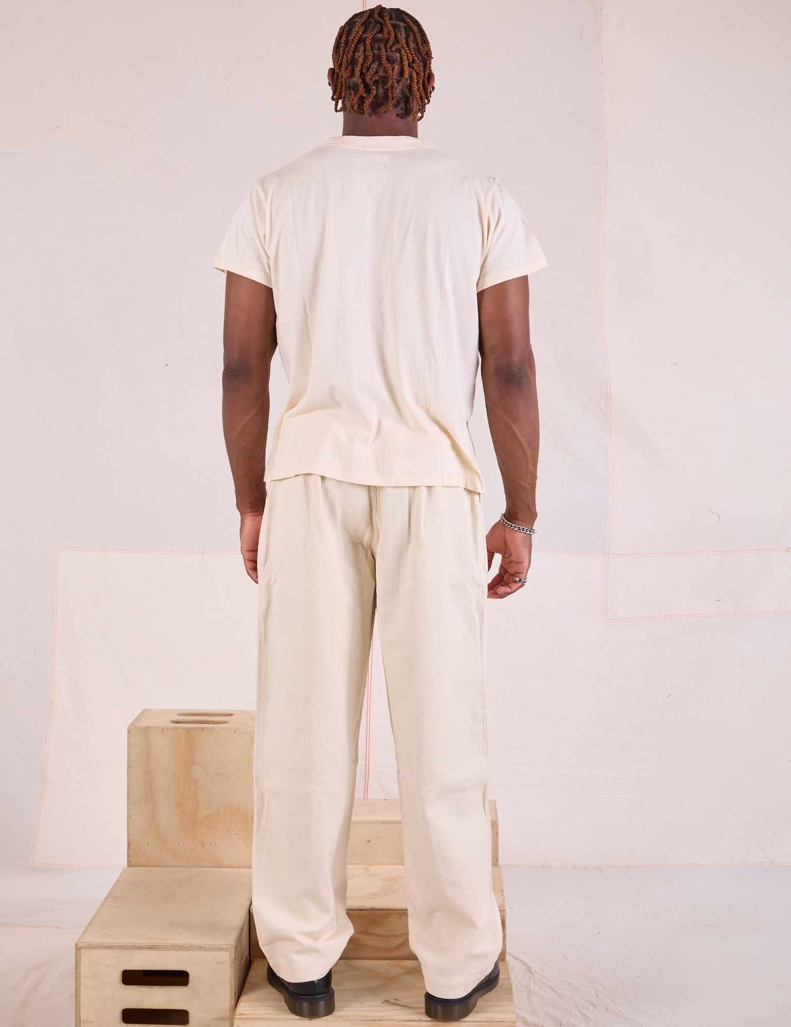 Back view of Heritage Trousers in Natural and Organic Vintage Tee in vintage tee off-white