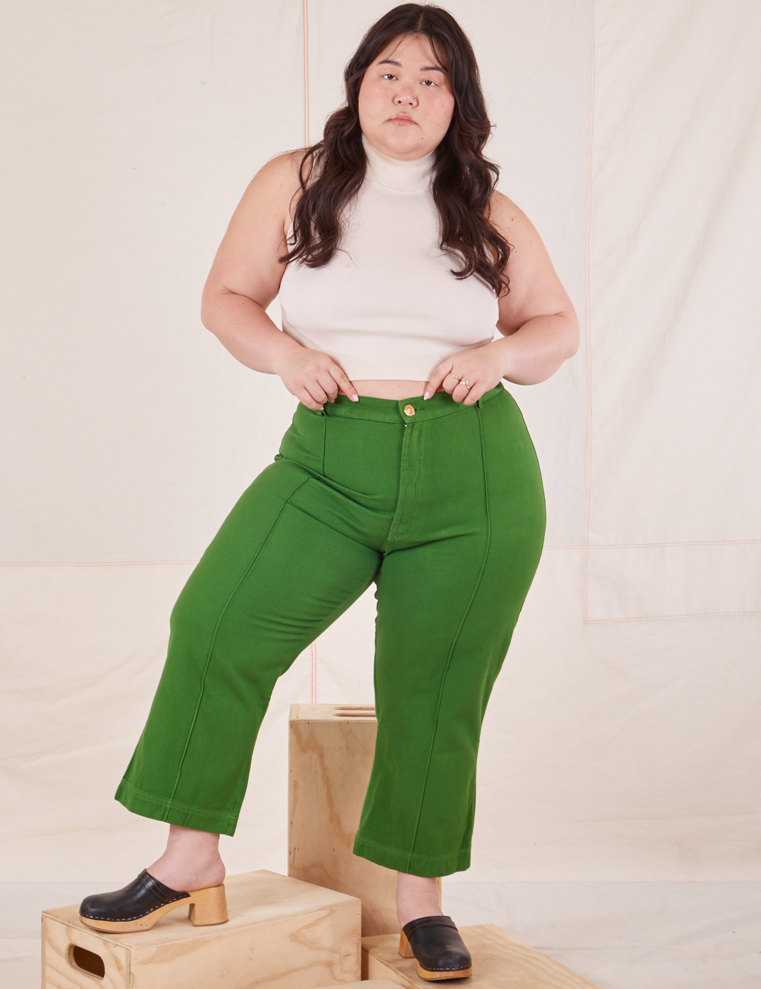 Ashley is 5&#39;7&quot; and wearing 1XL Petite Heritage Westerns in Lawn Green paired with vintage off-white Sleeveless Turtleneck