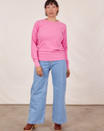 Tiara is wearing Honeycomb Thermal in Bubblegum Pink and light wash Sailor Jeans