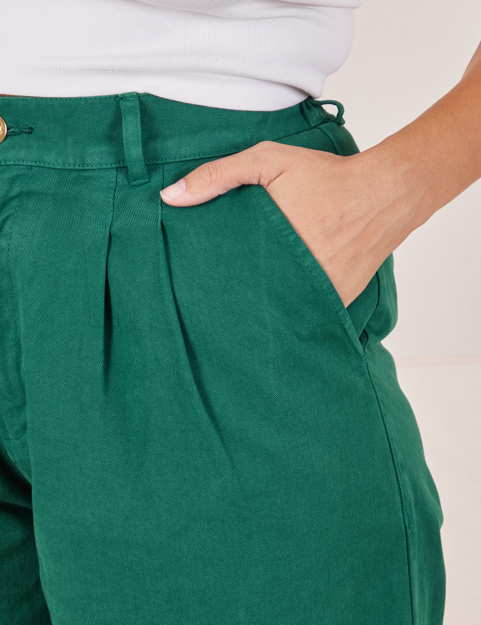 Front close up of Heavyweight Trousers in Hunter Green. Tiara has her hand in the pocket.