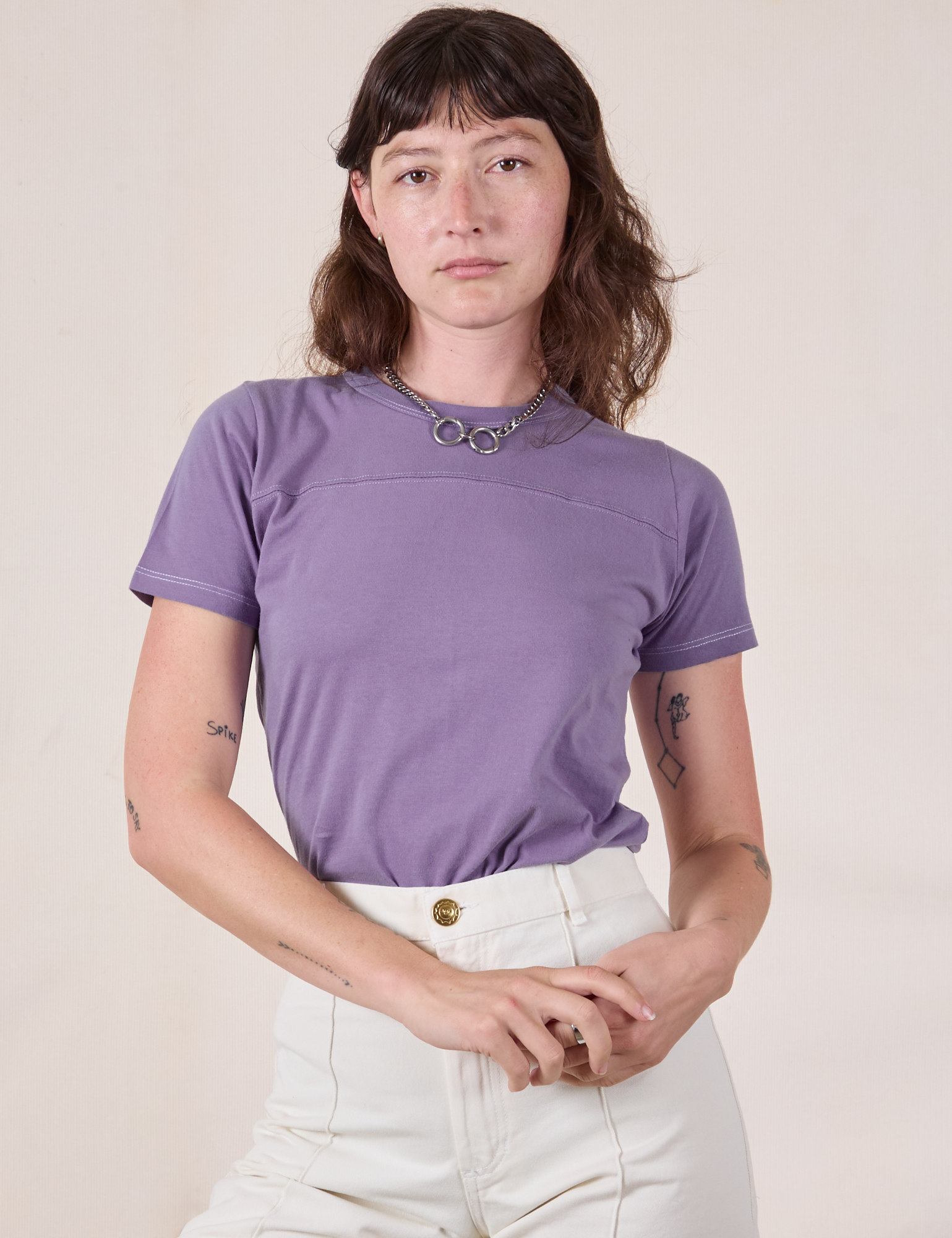 Alex is wearing a tucked in Jr. Varsity Tee in Faded Grape