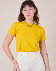 Alex is wearing JV Tee in Golden Yellow tucked into vintage tee off-white Western Pants