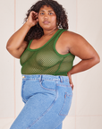 Angled view of Mesh Tank Top in Lawn Green and light wash Frontier Jeans worn by Morgan