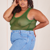 Angled view of Mesh Tank Top in Lawn Green and light wash Frontier Jeans worn by Morgan