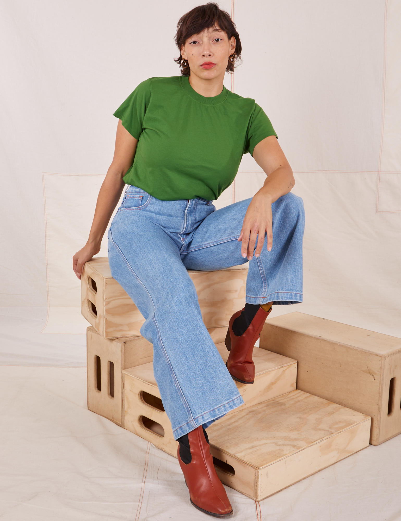 Tiara is wearing Organic Vintage Tee in Lawn Green and light wash Sailor Jeans
