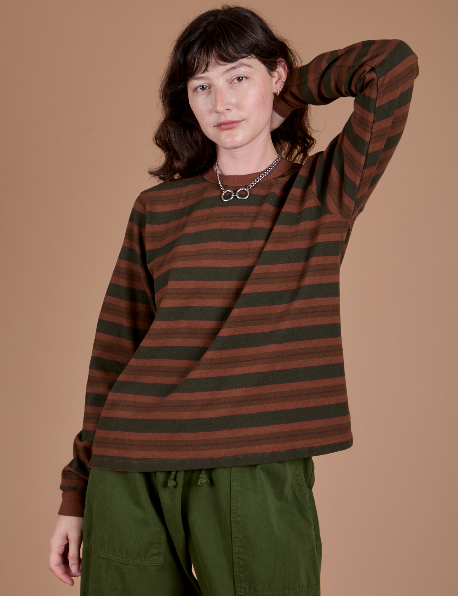 Alex is 5’8” and wearing P Long Sleeve Striped Burly Tee in Fudgesicle